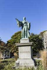 Fototapeta na wymiar Newport Tower and Channing Statue, Tauro Park, Newport Rhode Island USA. Summer, 2016