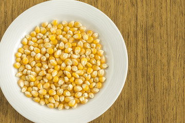 White dish with raw corn