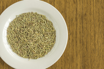 White dish with raw rosemary