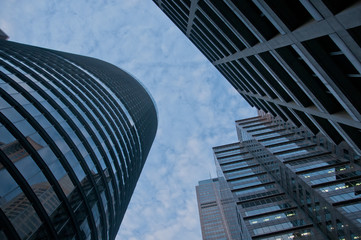 Fototapeta na wymiar Look up on high sky and modern corporate office buildings