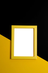 Empty yellow papper frame on colorful background with copy space.