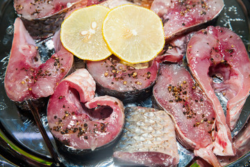 salmon fillet with lemon lime dill and spices on marble background. Set for salting fish. top view raw fish dishes pickled fish in Korean style