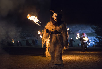 The Krampus come out of the wood during the traditional festival, Tarvisio, Julian Alps, Italy