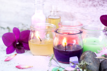 Obraz na płótnie Canvas spa composition including aromatic candle light, orchid flower ,soap, salt spa,massage oil,towels background