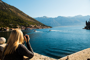 Fototapeta na wymiar Photographer taking a scenic picture of the sea during a summer day whilst travelling in Europe