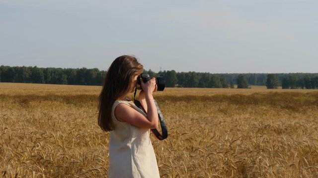 Woman photographer takes photo of goldish whietfield