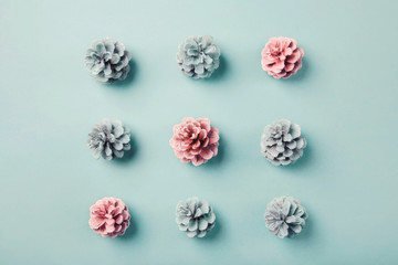 Game of tic-tac-toe presented with pink and blue pine cones