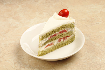 Slice of delicious cherry tomato cake on white plate.