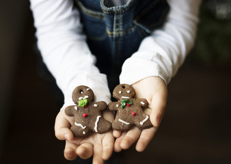 Little boy holding Christmas cookies