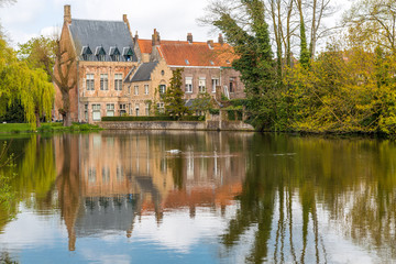 Fototapeta na wymiar Ancient Buildings Reflected in Minnewater Lake, Bruges, Belgium