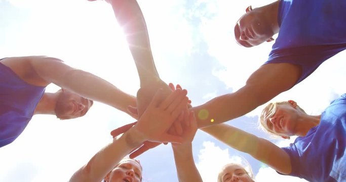 Fit people forming hands stack in boot camp 