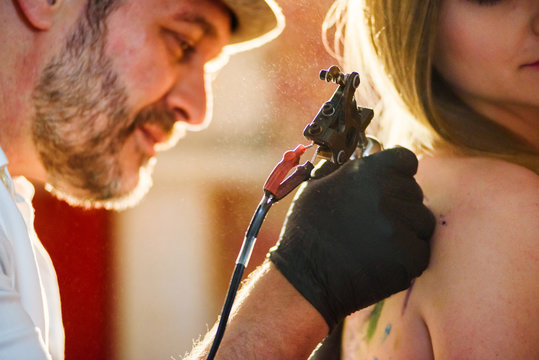 Young Attractive Girl Getting Tattoo