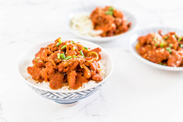 fried pork with spicy korean sauce (bulgogi) on top rice