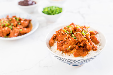 fried pork with spicy korean sauce (bulgogi) on top rice