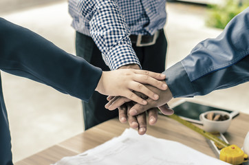 business, building, partnership, gesture and people concept , stacking hands express their teamwork and cooperation.