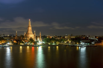 Wat Arun Ratchawararam Ratchawaramahawihan or  Wat Arun meaning Temple of Dawn on Chao Phraya River at night , Bangkok , Thailand