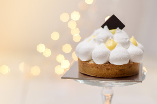 Gorgeous lemon meringue tart and bokeh background 