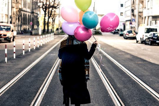 woman with colorful balloons - Powered by Adobe