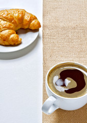 Coffee cup and croissant breakfast in the morning 