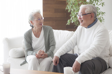 An elderly couple relaxing on the sofa