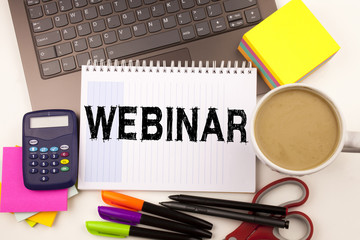 Webinar text in the office with surroundings such as laptop, marker, pen, stationery, coffee. Business concept for Online Training Development Business Workshop white background with copy space