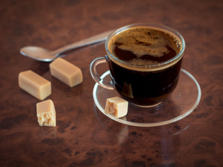 Empty coffee Cup with spoon on the vintage brown table.