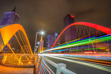 Fototapeta premium Modern city highway arc bridge night landscape of car light trails