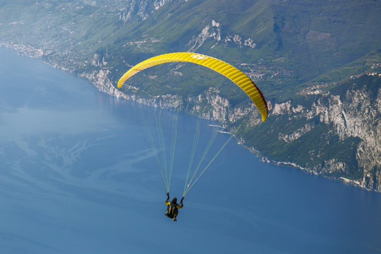 Paragliding flying from Mount Baldo above Garda lake, Verona, Veneto, italy