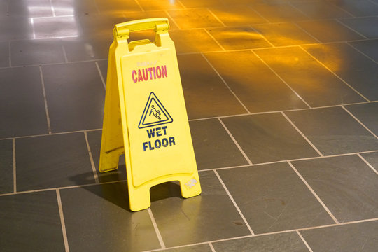 Slippery when wet warning sign in doors on the floor