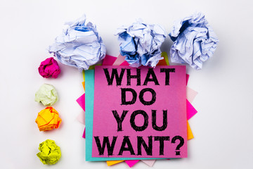 Writing text showing What Do You Want written on sticky note in office with screw paper balls. Business concept for Asking Opportunity Development Questions on the white isolated background.