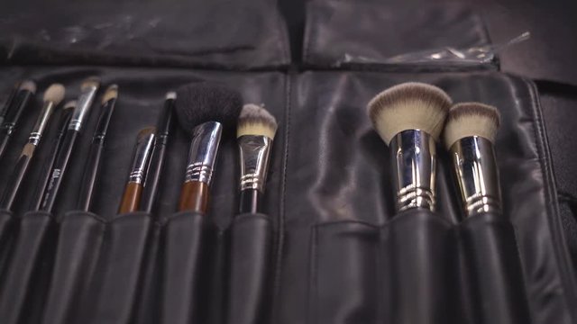 a set of brushes of a professional make-up artist in a case. Brushes are on the table. 4 k