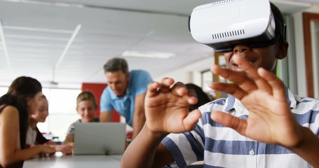 African American schoolboy using virtual reality headset 