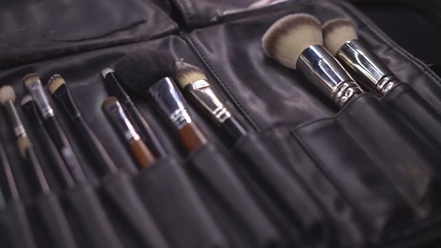 a set of brushes of a professional make-up artist in a case. Brushes are on the table. 4 k