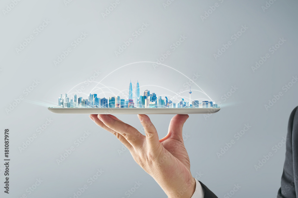 Wall mural waiter hand holding an empty digital tablet with smart cityscape and network connection concept . is