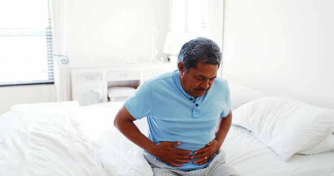 Upset senior man suffering from stomachache 