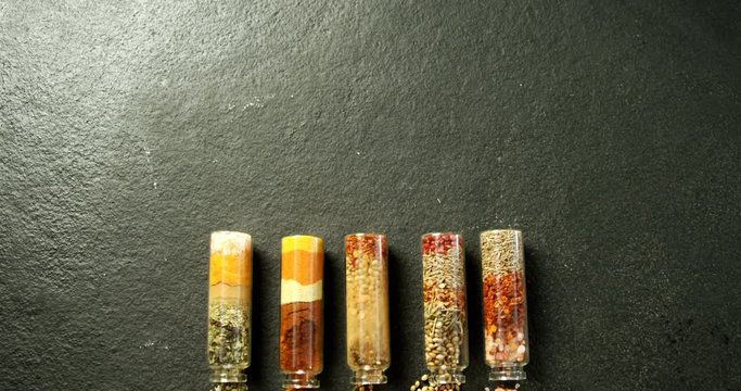 Various spices spilled out of jar 