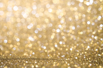 Gold Abstract Christmas twinkled bright background with bokeh defocused lights . Lights Festive background concept.