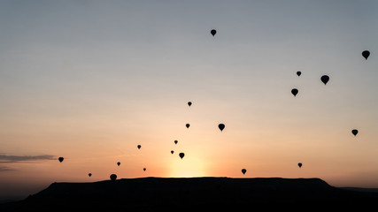 silhouettes of hot air balloons in Cappadocia, Turkey