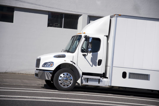 White mid power size semi truck with box trailer for city delivery and local shipping