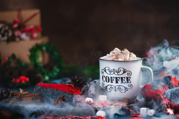 Hot chocolate with marshmallows in a cozy enamel mug with steam and Christmas decorations