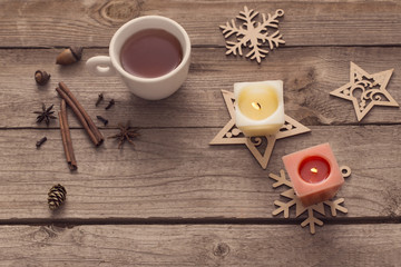 candles and Christmas decoration on wooden background