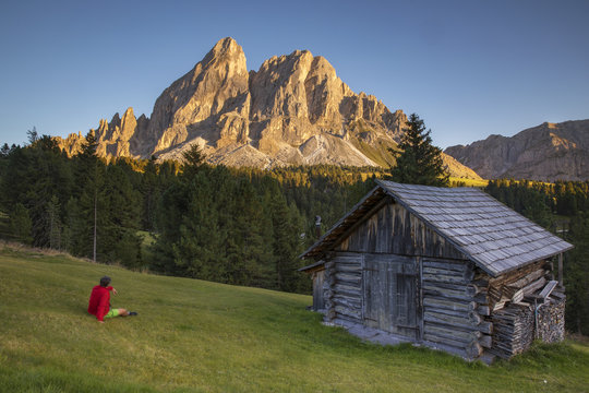 Hiker looks the Sass De Putia at sunset , Erbe Pass, Val Badia, Dolomites, Italy
