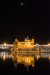 Golden Temple Glowing at Night with Moon and Reflection in Amritsar, Punjab