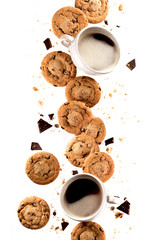 Cup of coffee with flying cookies.