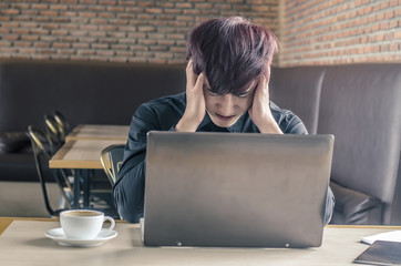 Portrait of an upset businessman at desk in cafe. Businessman being depressed by working in cafe....