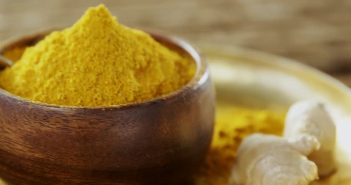 Turmeric powder in bowl on a plate 