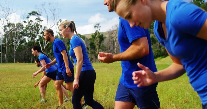 Fit people jogging in boot camp 