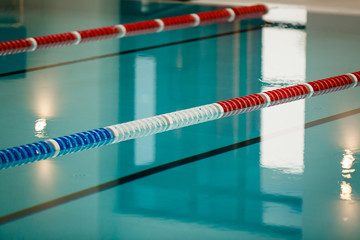 The view of an empty public swimming pool indoors lanes of a competition swimming pool sport