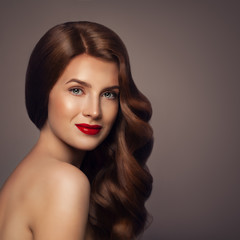 Beauty Portrait of Redhead Woman with Healthy Wavy Hair. Elegant Lady with Perfect Hairstyle