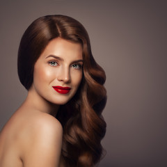 Fototapeta premium Beauty Portrait of Redhead Woman with Healthy Wavy Hair. Elegant Lady with Perfect Hairstyle
